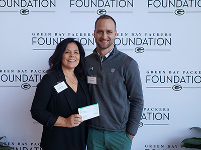 Stephanie Sklba, vice president, Community and Government Relations accepts donation.
